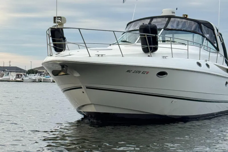  Yacht Photos Pics 2000 Cruisers Yachts 3870 Express docked in a marina, front view.