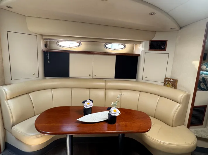 Yacht Photos Pics Luxurious interior of 2000 Cruisers Yachts 3870 Express with elegant seating and table.