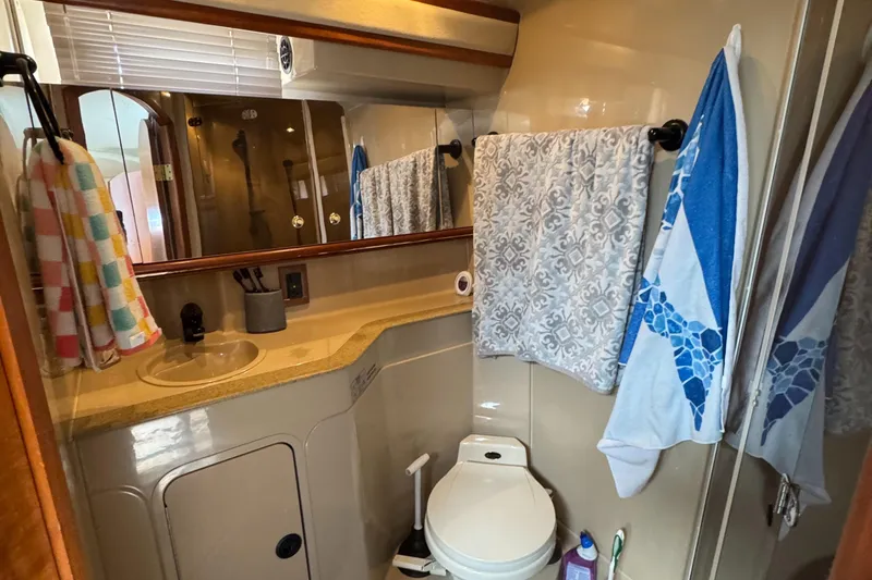  Yacht Photos Pics Bathroom of 2000 Cruisers Yachts 3870 Express with sink, toilet, and towels.