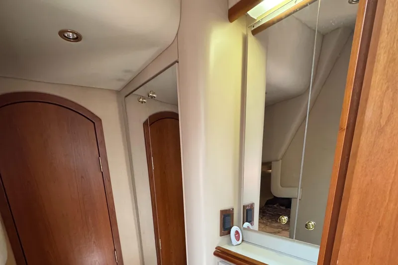  Yacht Photos Pics Interior of 2000 Cruisers Yachts 3870 Express with wooden door and mirrored cabinet.