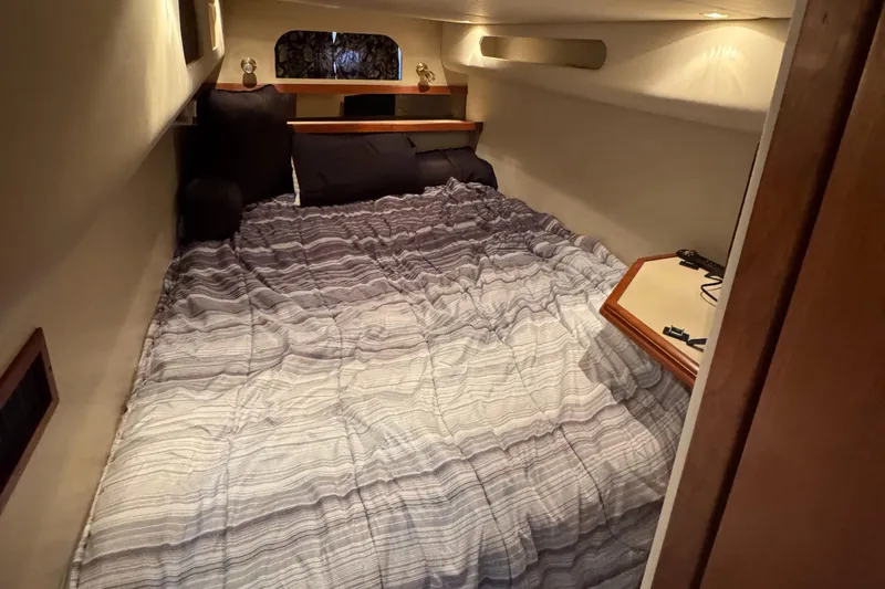  Yacht Photos Pics Cozy cabin interior of 2000 Cruisers Yachts 3870 Express with comfortable bedding.