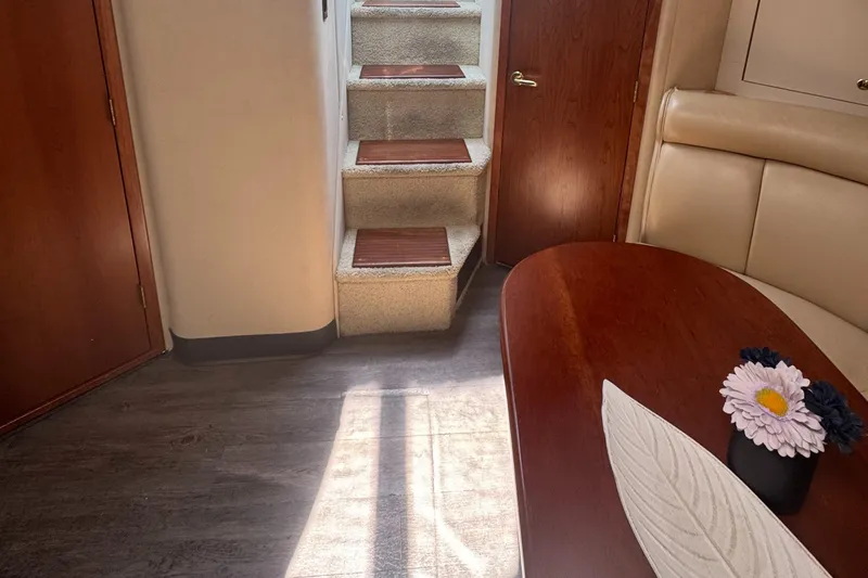  Yacht Photos Pics Interior of 2000 Cruisers Yachts 3870 Express, featuring stairs, table, and floral decor.
