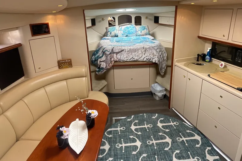  Yacht Photos Pics Luxurious interior of 2000 Cruisers Yachts 3870 Express with cozy seating and kitchenette.