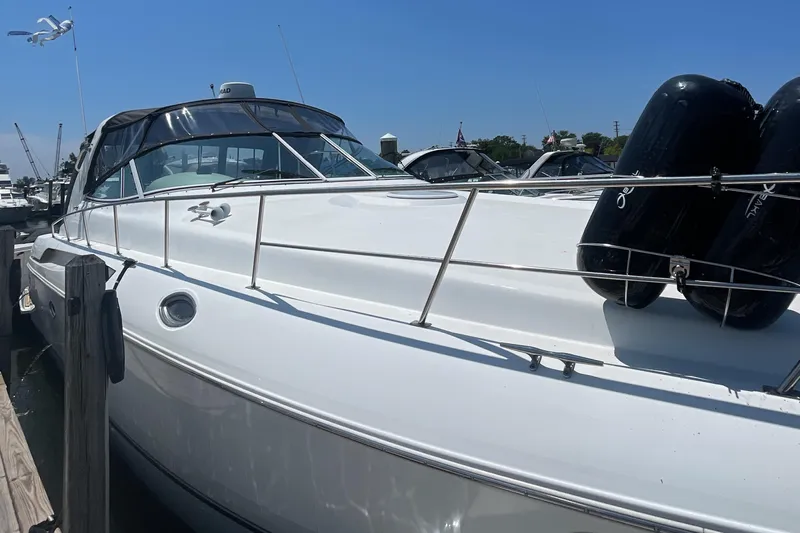  Yacht Photos Pics 2000 Cruisers Yachts 3870 Express docked, featuring sleek white design and black fenders.