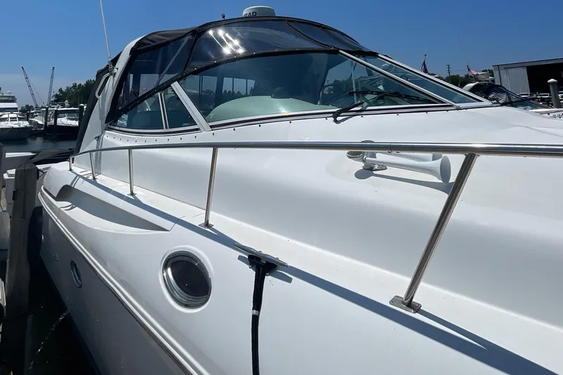  Yacht Photos Pics 2000 Cruisers Yachts 3870 Express docked at marina, side view.