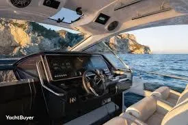 47 Verve Yacht Photos Pics Interior view of 2021 Azimut Verve 47 yacht with ocean and cliffs in background.