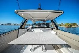 47 Verve Yacht Photos Pics 2021 Azimut Verve 47 yacht interior with table, under clear blue sky.