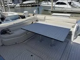 47 Verve Yacht Photos Pics 2021 Azimut Verve 47 yacht interior with seating and table, docked at marina.