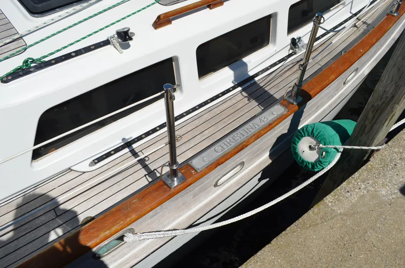 Fleur De Lys Yacht Photos Pics 1986 Hans Christian Christina yacht deck with wooden railings and mooring rope.