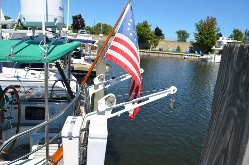 Fleur De Lys Yacht Photos Pics Sailboat docked with American flag, Hans Christian Christina 1986 model, in a marina.