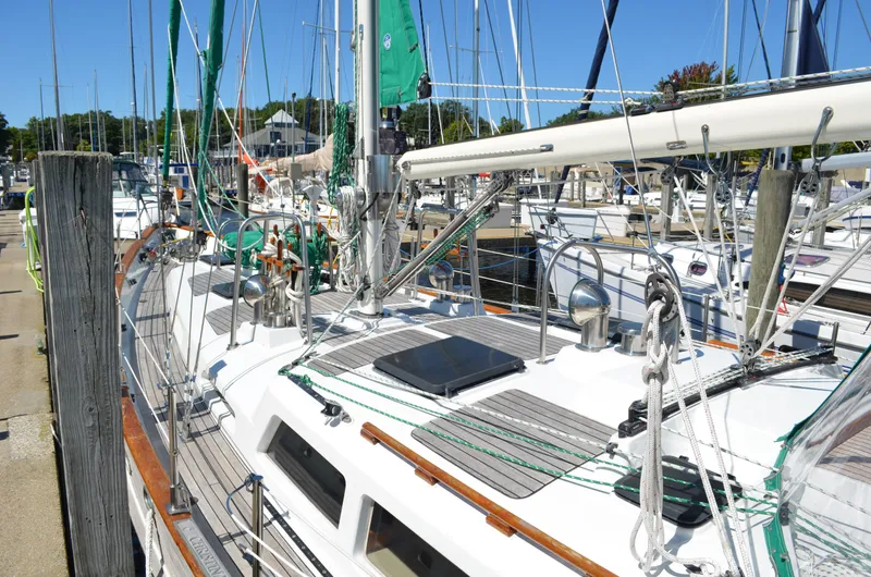 Fleur De Lys Yacht Photos Pics Sailboat docked at marina, 1986 Hans Christian Christina model, with green sails and wooden deck.