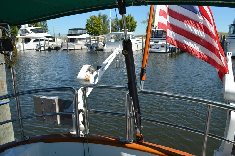 Fleur De Lys Yacht Photos Pics Sailboat docked in marina, Hans Christian Christina 1986, with American flag and surrounding yachts.