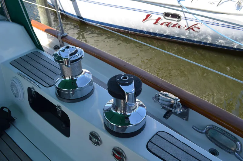 Fleur De Lys Yacht Photos Pics Sailboat deck with winches, Hans Christian Christina 1986 model, docked near another boat.