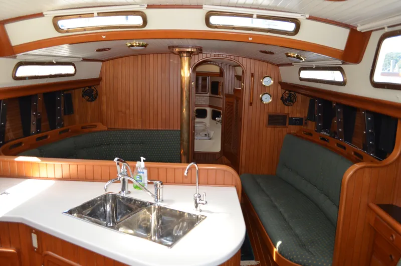 Fleur De Lys Yacht Photos Pics Interior of 1986 Hans Christian Christina sailboat with wood paneling and dual sinks.