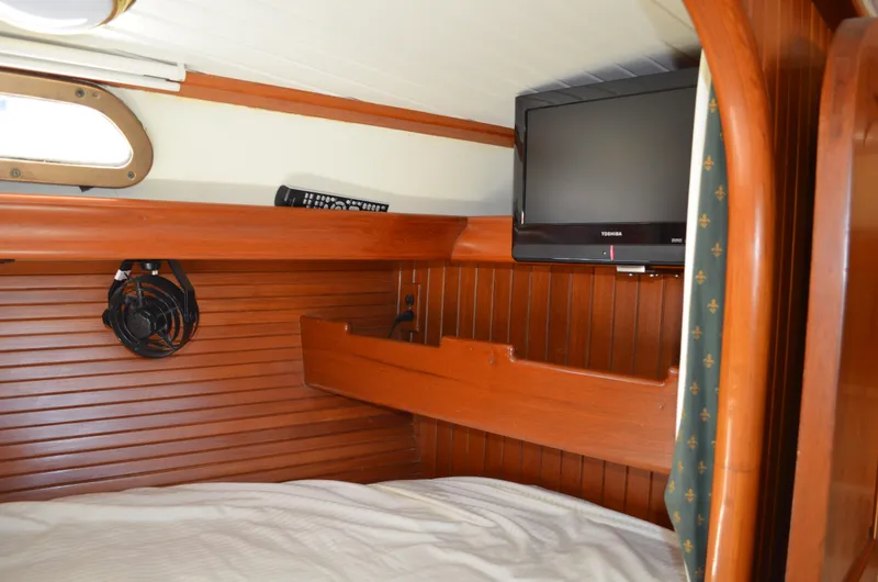 Fleur De Lys Yacht Photos Pics Cozy cabin interior of 1986 Hans Christian Christina yacht with TV and wooden paneling.