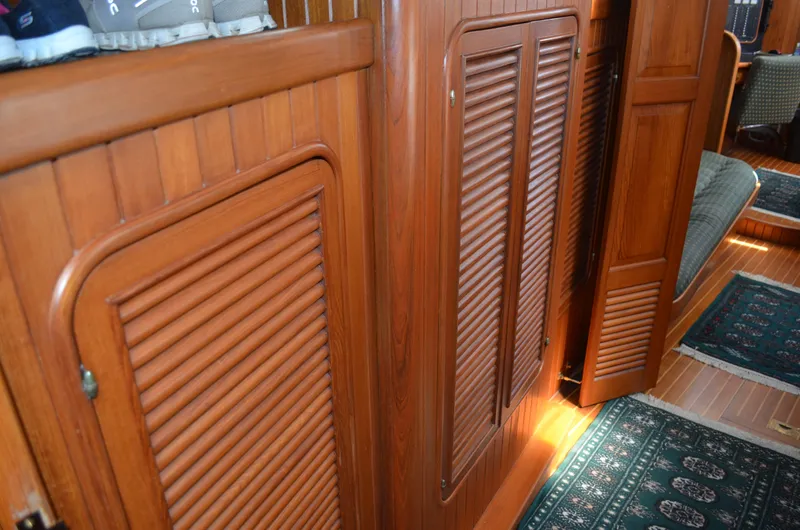 Fleur De Lys Yacht Photos Pics Interior of 1986 Hans Christian Christina yacht with wooden paneling and carpeted flooring.