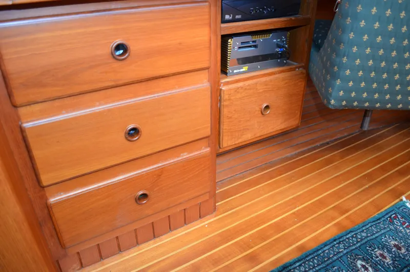 Fleur De Lys Yacht Photos Pics Wooden interior of 1986 Hans Christian Christina boat with drawers and patterned upholstery.