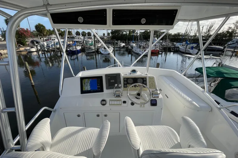  Yacht Photos Pics Helm of 2003 Egg Harbor 37 Sport Fisher with marina view, featuring navigation equipment.