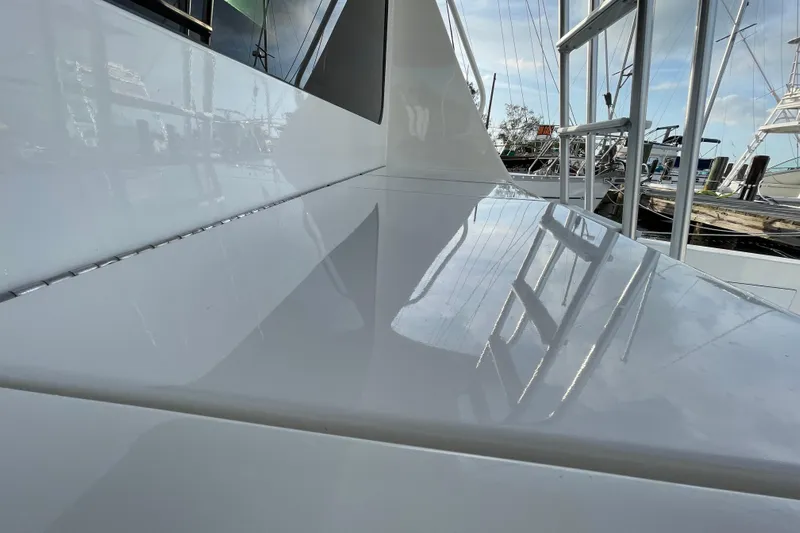  Yacht Photos Pics 2003 Egg Harbor 37 Sport Fisher yacht deck with sleek, reflective surface and marina view.