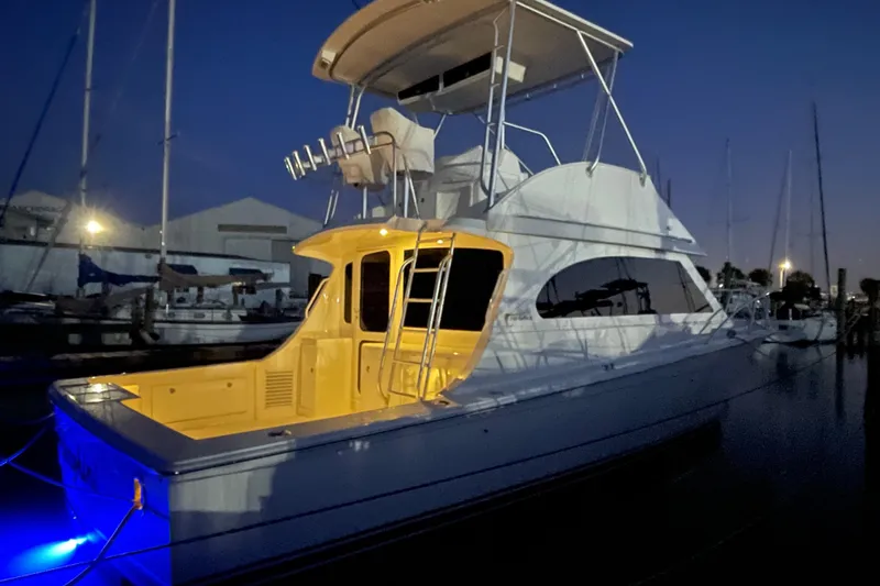  Yacht Photos Pics 2003 Egg Harbor 37 Sport Fisher yacht illuminated at night in a marina setting.