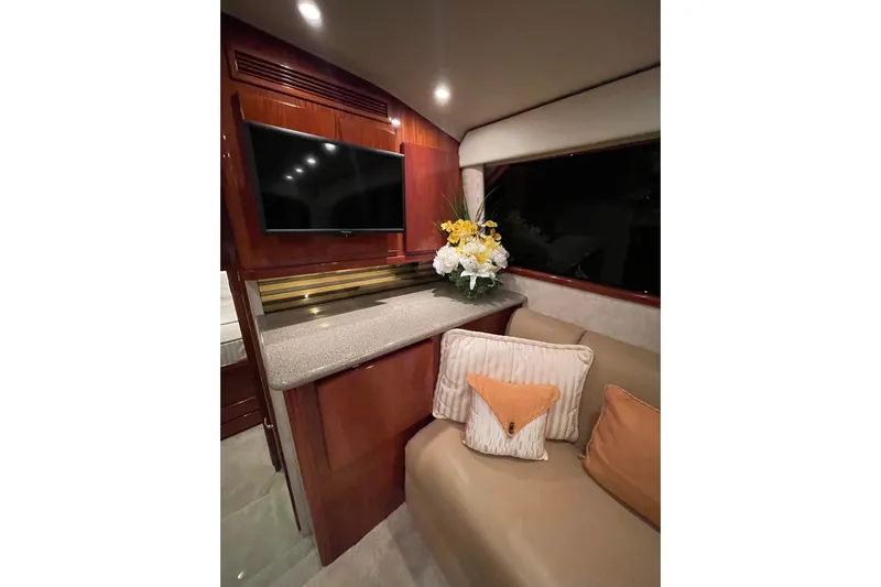  Yacht Photos Pics Luxurious interior of 2003 Egg Harbor 37 Sport Fisher with TV, flowers, and cushions.