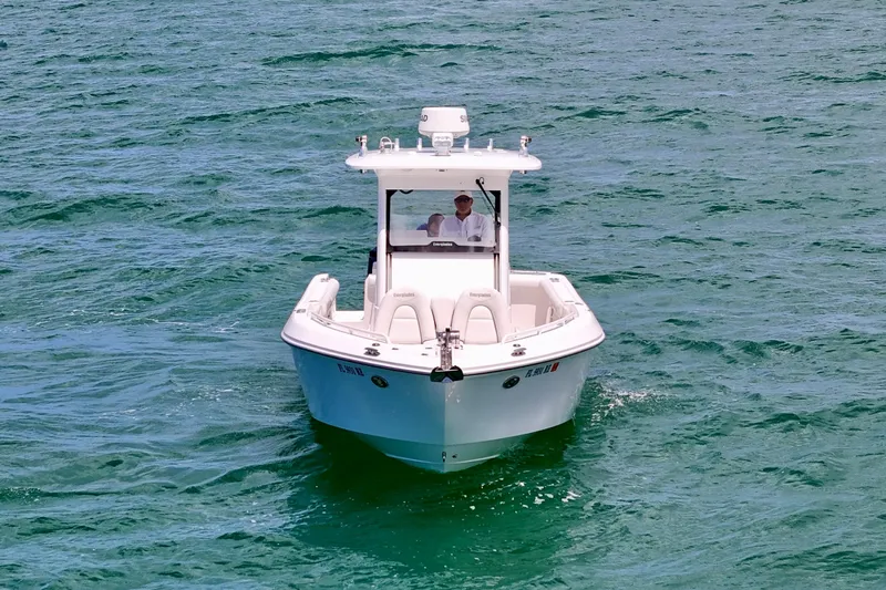 Yacht Photos Pics 2015 Everglades 295 Center Console boat navigating on clear blue water.