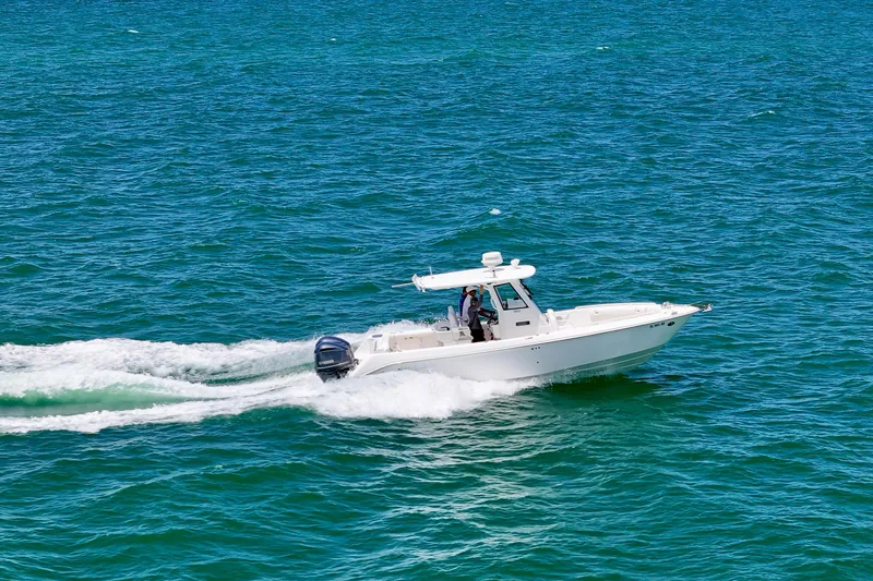  Yacht Photos Pics 2015 Everglades 295 Center Console boat cruising on open water.