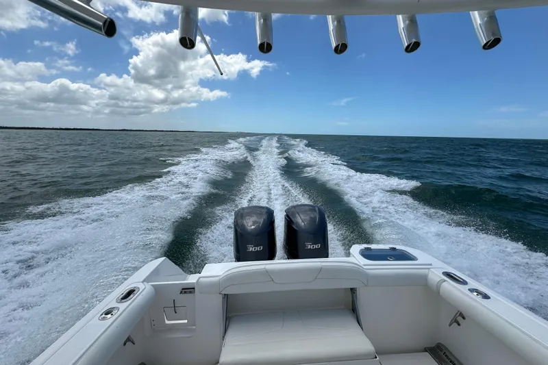  Yacht Photos Pics 2015 Everglades 295 Center Console boat cruising on open water, twin engines visible.