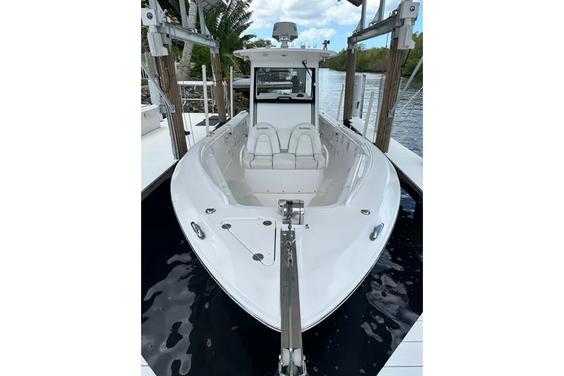  Yacht Photos Pics 2015 Everglades 295 Center Console boat docked on calm water.