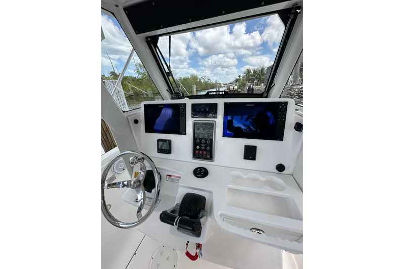  Yacht Photos Pics 2015 Everglades 295 Center Console boat dashboard with steering wheel and navigation screens.
