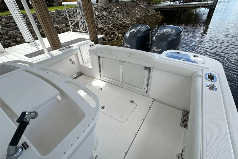  Yacht Photos Pics 2015 Everglades 295 Center Console boat with dual engines docked by water.