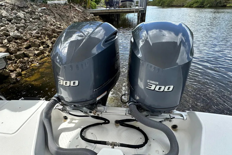  Yacht Photos Pics Twin Yamaha 300 engines on a 2015 Everglades 295 Center Console boat by the water.
