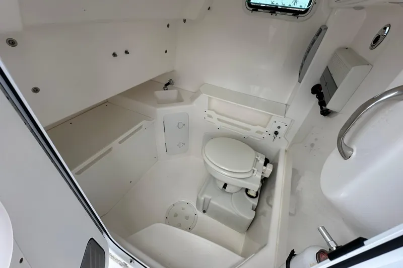  Yacht Photos Pics 2015 Everglades 295 Center Console boat interior with compact marine toilet.