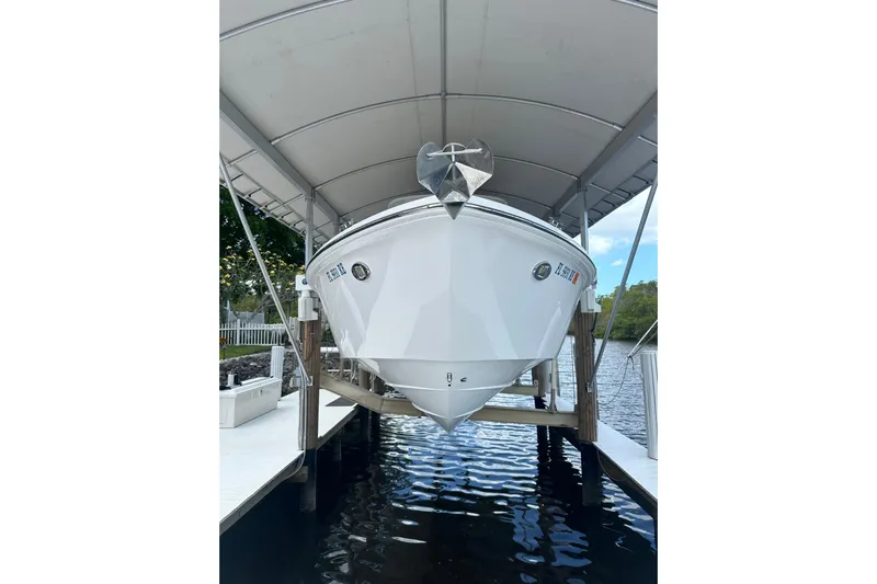  Yacht Photos Pics 2015 Everglades 295 Center Console boat docked under a canopy.