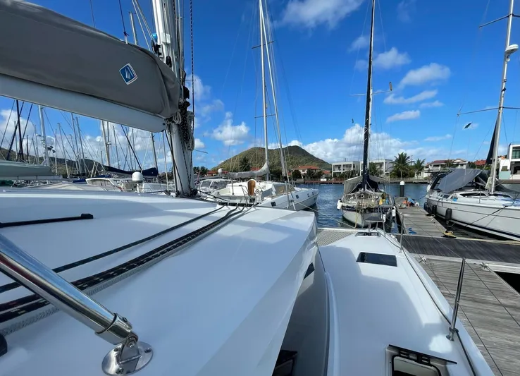  Yacht Photos Pics 2019 Fountaine Pajot Lucia 40 catamaran docked in a sunny marina.