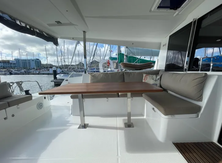  Yacht Photos Pics Spacious deck of 2019 Fountaine Pajot Lucia 40 catamaran with comfortable seating and table.