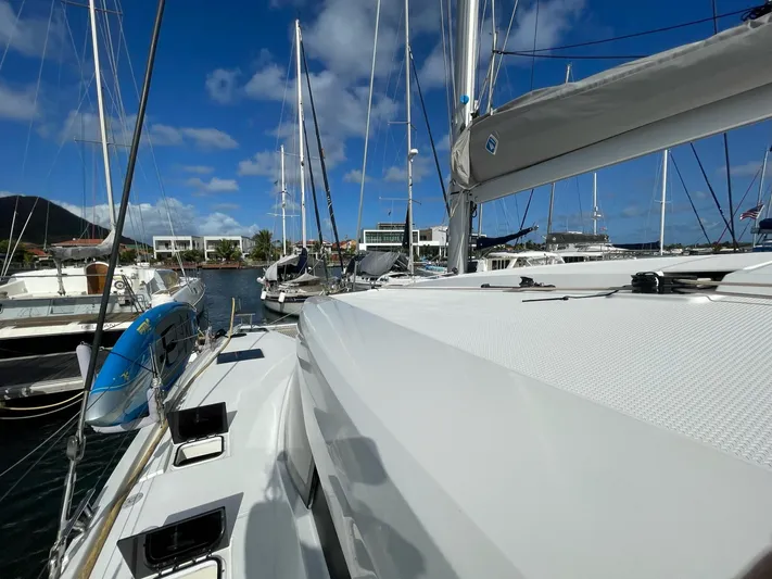  Yacht Photos Pics 2019 Fountaine Pajot Lucia 40 catamaran docked in a sunny marina.