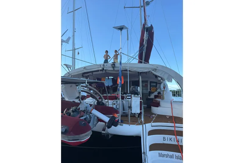 Manila Spirit Yacht Photos Pics Catamaran yacht "Bikini" from Marshall Islands, Dean 5000 model, 2012, docked with people onboard.