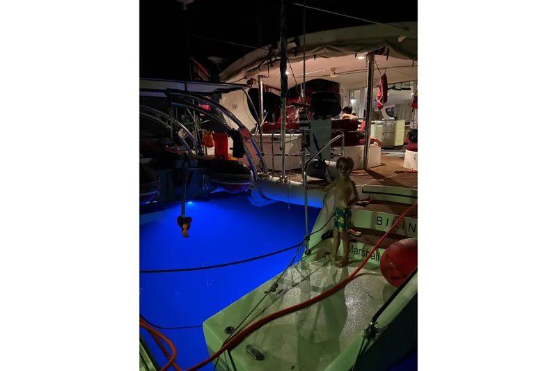 Manila Spirit Yacht Photos Pics Child on a 2012 Dean 5000 yacht at night with blue underwater lights.