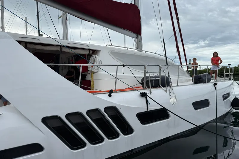 Manila Spirit Yacht Photos Pics Sailing catamaran Dean 5000, 2012 model, docked with people on deck.