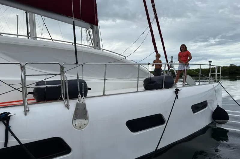 Manila Spirit Yacht Photos Pics Children on a 2012 Dean 5000 catamaran, docked with overcast skies.