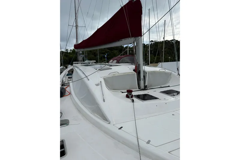 Manila Spirit Yacht Photos Pics 2012 Dean 5000 sailboat with red sail cover, docked in a marina.