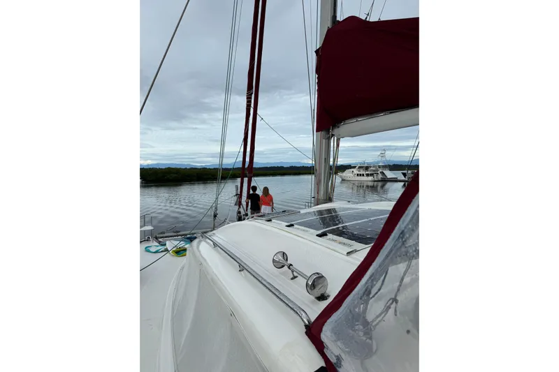 Manila Spirit Yacht Photos Pics Sailing on a 2012 Dean 5000 catamaran in a serene marina setting.