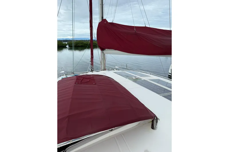 Manila Spirit Yacht Photos Pics Sailboat deck with maroon covers, Dean 5000 model, 2012, on calm water.