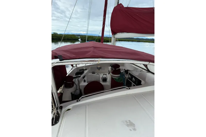 Manila Spirit Yacht Photos Pics 2012 Dean 5000 sailboat cockpit with maroon canopy, docked on calm water.