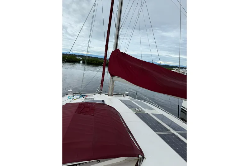 Manila Spirit Yacht Photos Pics Sailboat deck with maroon covers, Dean 5000 model, 2012, on calm waters.