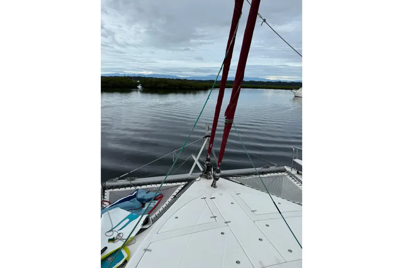 Manila Spirit Yacht Photos Pics Deck view of a 2012 Dean 5000 catamaran on calm waters under cloudy skies.