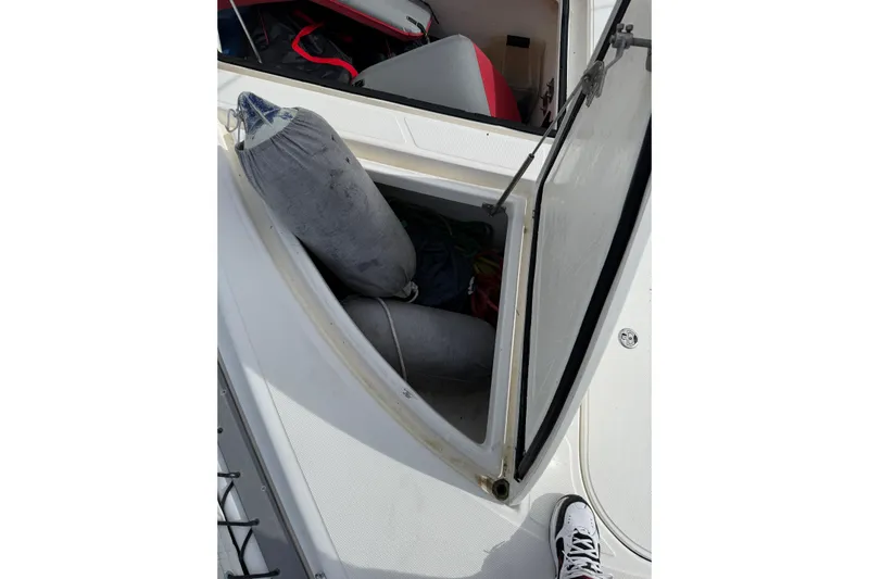 Manila Spirit Yacht Photos Pics Open storage compartment on a 2012 Dean 5000 boat, showing fenders and equipment.