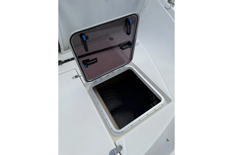Manila Spirit Yacht Photos Pics Open hatch on a 2012 Dean 5000 boat, revealing interior storage space.