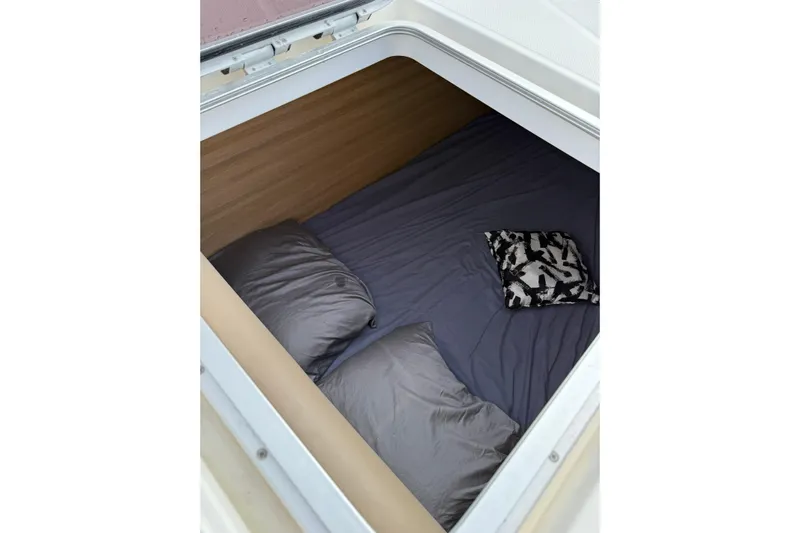 Manila Spirit Yacht Photos Pics Cozy sleeping area in a 2012 Dean 5000, featuring pillows and a patterned cushion.